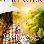 a woman looks at grapevines